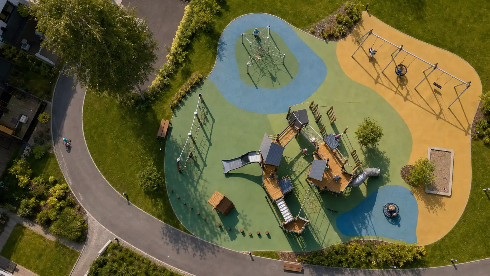 Aerial view of a new children’s playground with colourful safety surfacing in a courtyard